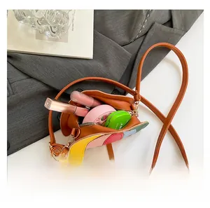 Detailed interior of a brown bucket bag with colorful stitching showing its storage capacity