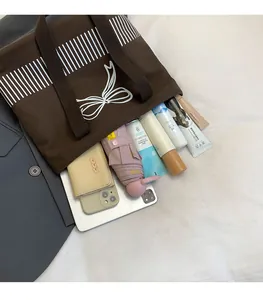 Interior view showing the large capacity of the brown canvas tote bag for essentials