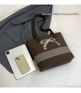 Canvas tote bag size comparison with smartphone and tablet showing large storage capacity