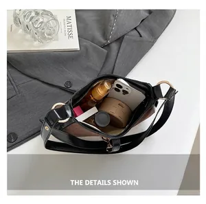 Top view of open crescent bag showing storage capacity for phone and cosmetics