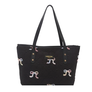 Quilted black tote bag with colorful bow embroidery and dual top handles for daily commute
