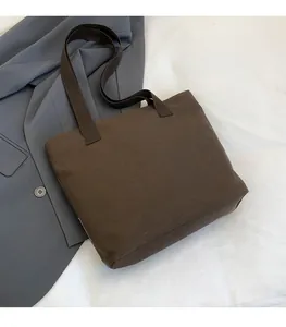Detail of high-density canvas tote bag in deep coffee brown with thick webbing straps