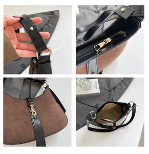 Detail view of suede hobo bag featuring gold hardware and inner compartment