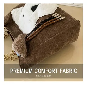Detail of brown corduroy shoulder bag with plush animal patch and braided drawstrings