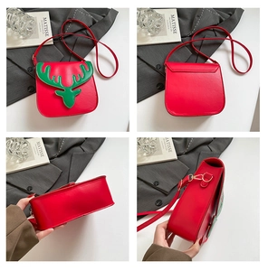 Detail view of red Christmas reindeer crossbody bag with green deer embroidery on faux leather