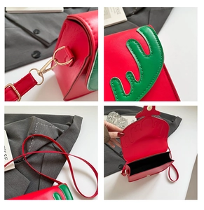Detail view of red Christmas crossbody bag with green antler accents and gold hardware