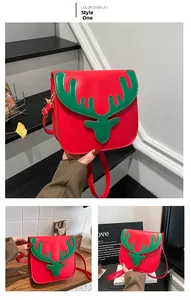 Close-up of red Christmas deer crossbody bag with green reindeer horn buckle detail