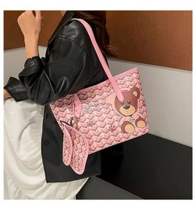 Detail showing pink bear print tote bag with shoulder straps worn by model