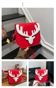 Detail of red Christmas reindeer crossbody bag with white leather patchwork and golden buckle