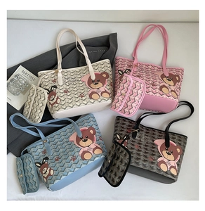 Detail view of colorful tote bags with chevron pattern and cute cartoon bear prints