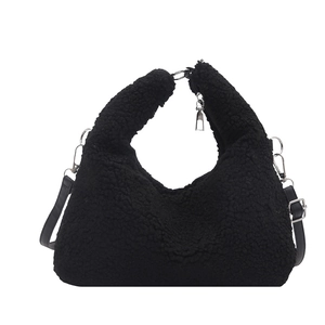Minimalist black plush tote bag with silver metal hardware and leather shoulder strap