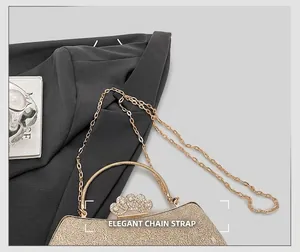 Detail of golden evening bag showing rhinestone crown clasp and delicate chain strap
