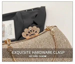Detail of gold evening bag featuring a rhinestone crown clasp and metal lace mesh texture