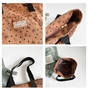 Detail view of corduroy tote bag with bow patterns, zipper closure and inner lining