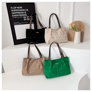 Quilted tote bags in four colors with leather straps and gold metal details on display
