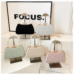 Detailed row of evening clutch bags in multiple colors with pearl rhinestone crown clasps