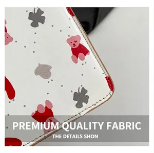 Close-up of premium leather material with red bear pattern and precise gray stitching