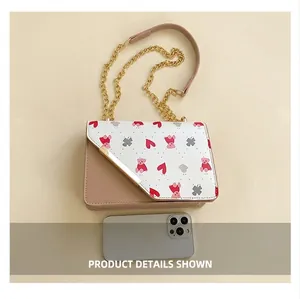 Close-up of the cherry bag flap featuring cute bear patterns and gold metal chain