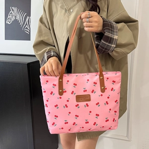 Pink cherry print oversized tote bag with brown leather straps and fashion label