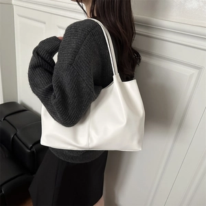 Minimalist white leather tote bag for women shown with autumn winter outfit