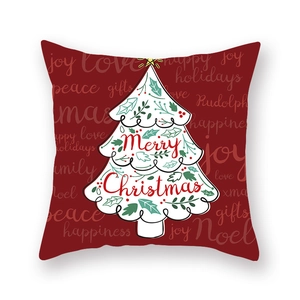Détail d'une taie d'oreiller rouge de Noël avec sapin blanc et texte festif
