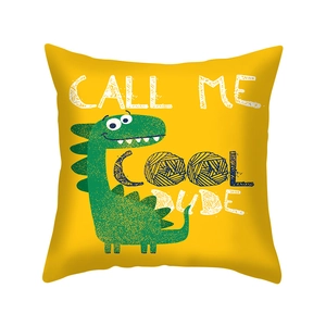 Detail of yellow pillowcase featuring a cartoon dinosaur and Call Me Cool Dude slogan