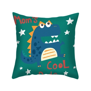 Close-up of square cushion cover with blue dinosaur print and Mom's COOL Dude text
