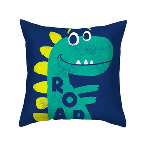 Detail of square navy pillowcase with green cartoon dinosaur print and yellow spikes