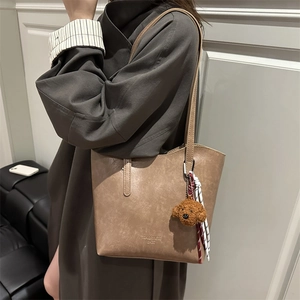 Sac fourre-tout vintage caramel avec breloque chiot en peluche et écharpe rayée à l'épaule