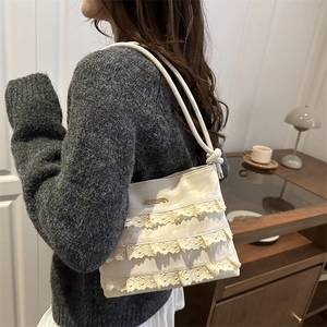 French style cream white lace shoulder bag with tiered ruffles and gold logo