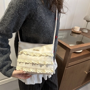 Chic cream lace crossbody bag with plaid texture and metal logo for women on model