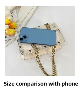 Comparaison de taille d'un sac bandoulière beige avec un smartphone sur tissu