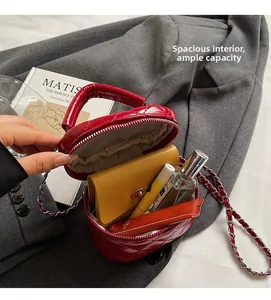 Internal view of mini red quilted leather box bag showing capacity for daily essentials