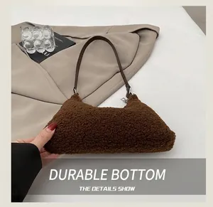Detail of plush teddy fleece bag texture with brown leather strap and silver zipper
