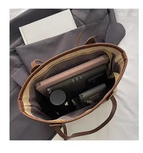 Spacious interior of brown faux leather tote bag fitting a 14-inch laptop and essentials