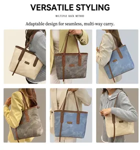 Detail view of large tote bags in cream, grey and blue with brown leather handles