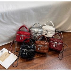 Close-up of quilted mini box bags in six metallic and glossy colors with heart-shaped charms