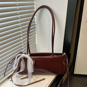 Chic burgundy patent leather baguette bag with a decorative lace bow for women