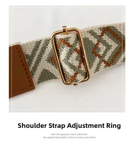 Detail of adjustable woven shoulder strap with green geometric patterns and gold metal buckles