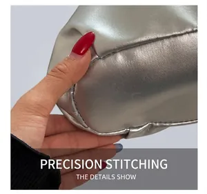 Close-up of precise stitching on liquid silver metallic PU bucket bag texture