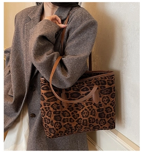 Detailed view of leopard print tote bag styled with a grey oversized tweed blazer