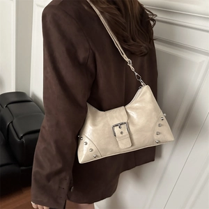 Minimalist beige dumpling shoulder bag with silver studs and buckle for women's style