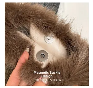 Close-up of magnetic snap closure on brown faux fur handbag with leather base detail