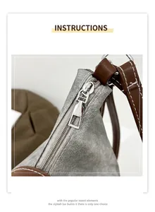 Close-up of durable gray fabric texture with brown leather strap and smooth metal zipper