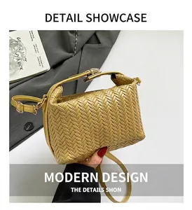 Detail of yellow woven texture shoulder bag with golden metal clasp and crossbody strap
