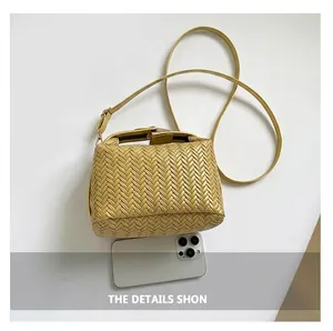 Size comparison of the woven texture handbag alongside a smartphone for scale