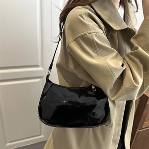Minimalist black patent leather underarm shoulder bag with a sleek glossy finish