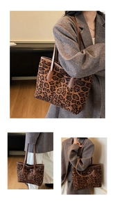 Detail of leopard print tote bag with dark brown leather straps on wool coat