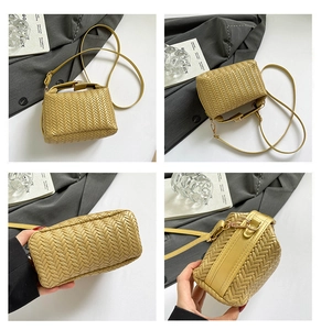 Detail view of mustard yellow woven handbag showing adjustable straps and square design