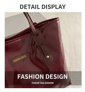 Close-up of shiny burgundy patent leather tote bag with Fashion & Bags leather label detail